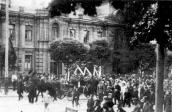 Funeral procession before house…